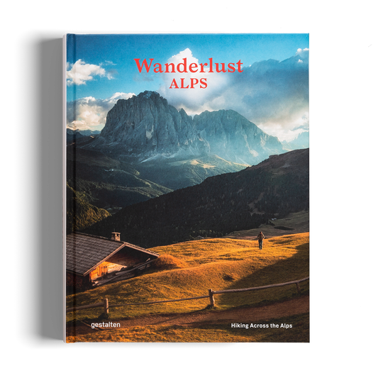 Book titled 'Wanderlust Alps' with a mountain landscape on the cover