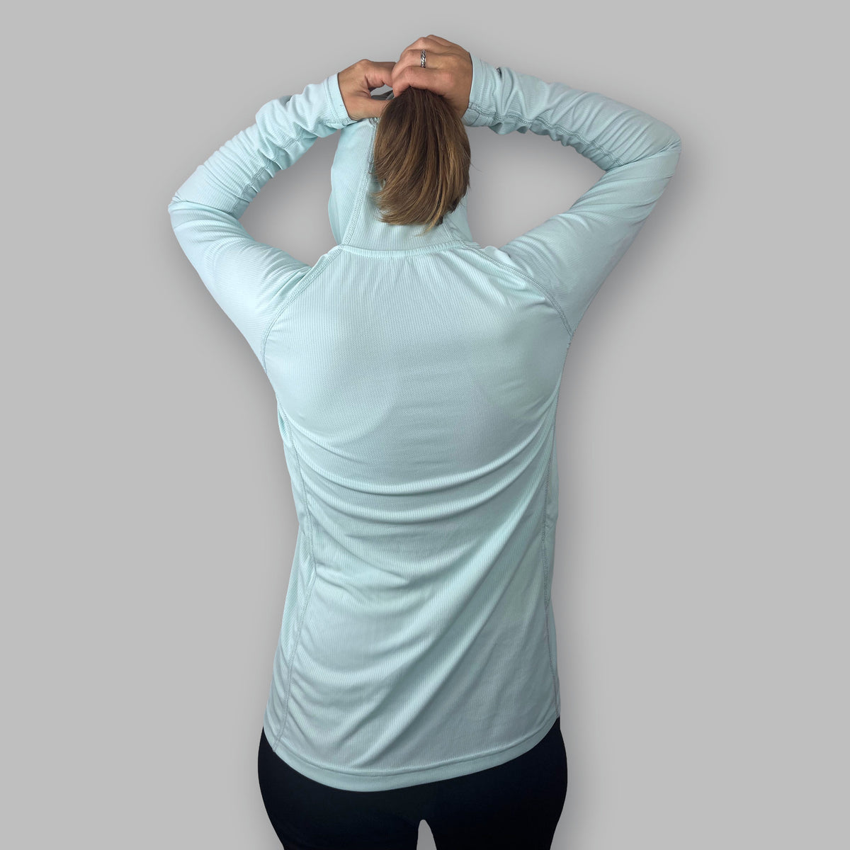 Women's Soltera Hoody in glacial green, back view with arms raised
