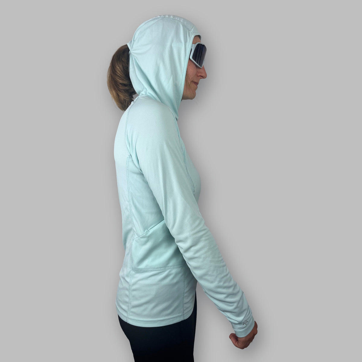 Women's Soltera Hoody in glacial green, side view with the hood up