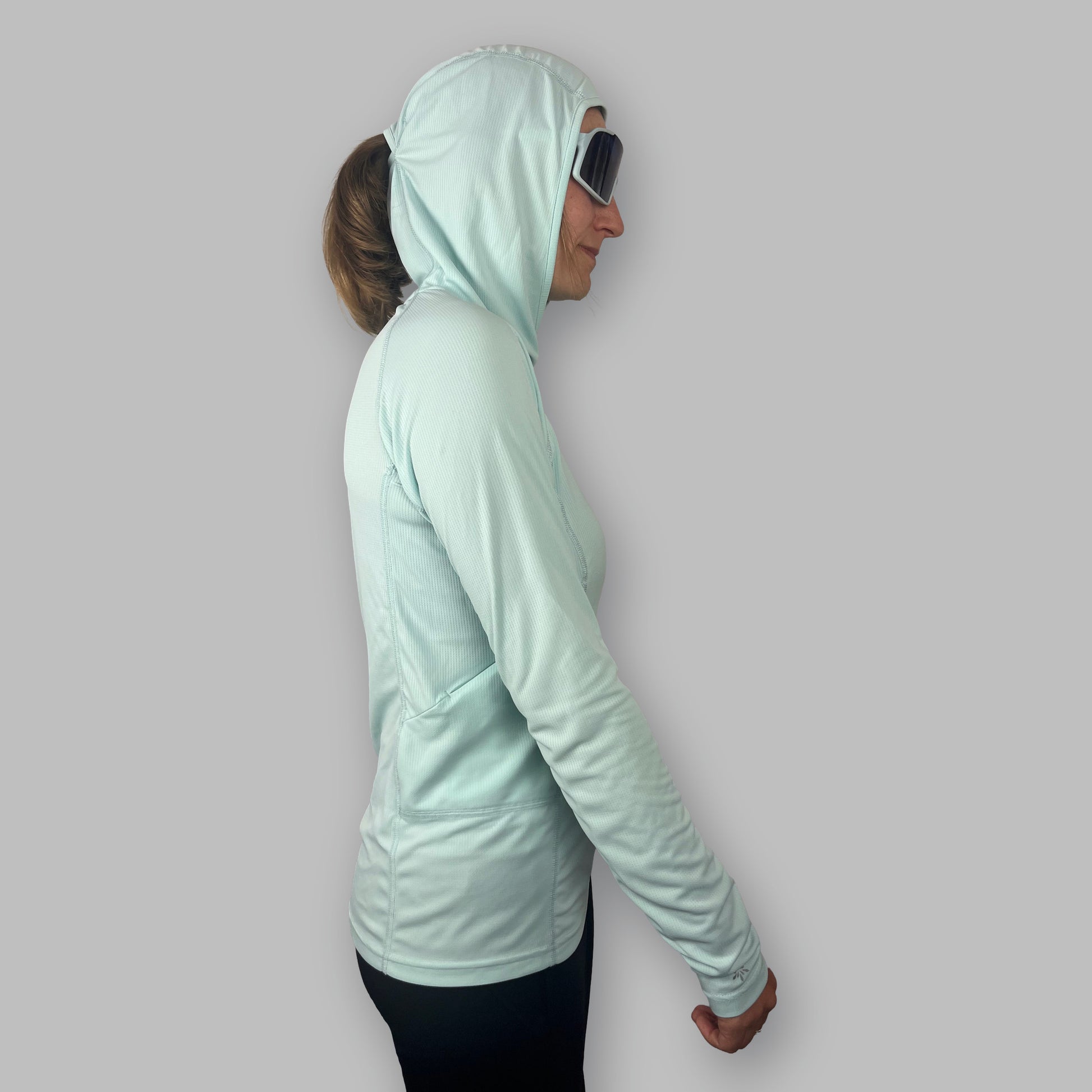 Women's Soltera Hoody in glacial green, side view with the hood up