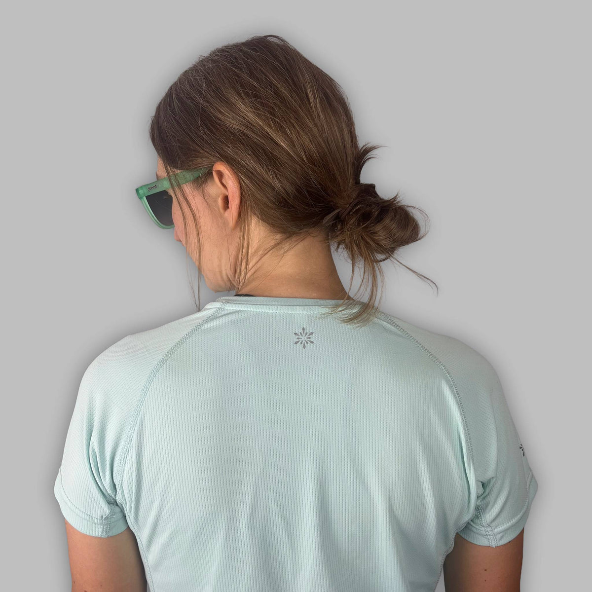 Back detail of the Soltera Tee in glacial green, showing the raglan seams and Vertura logo at the neck