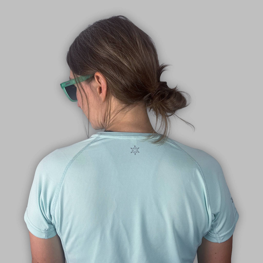 Back detail of the Soltera Tee in glacial green, showing the raglan seams and Vertura logo at the neck